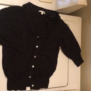 Black button up shawl with woven collar.